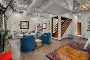 A modern living room with a sofa set, a coffee table, and a patterned rug.