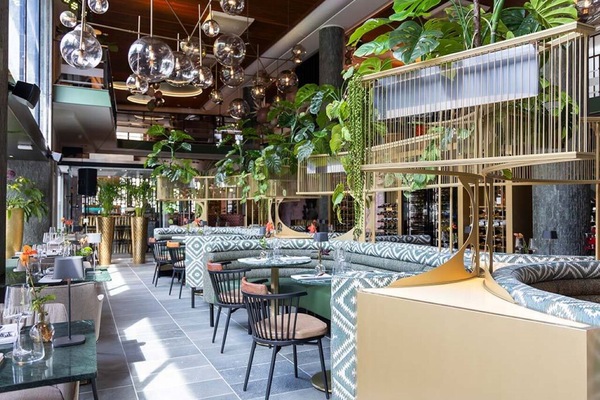 Step into a vibrant dining hall filled with botanical elegance.