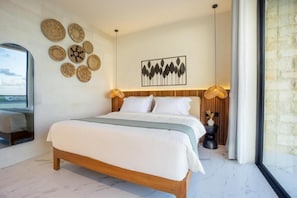 A modern bedroom with a wooden bed, white bedding, a wall-mounted artwork, and a large window. - White Residence (KUTA SELATAN)