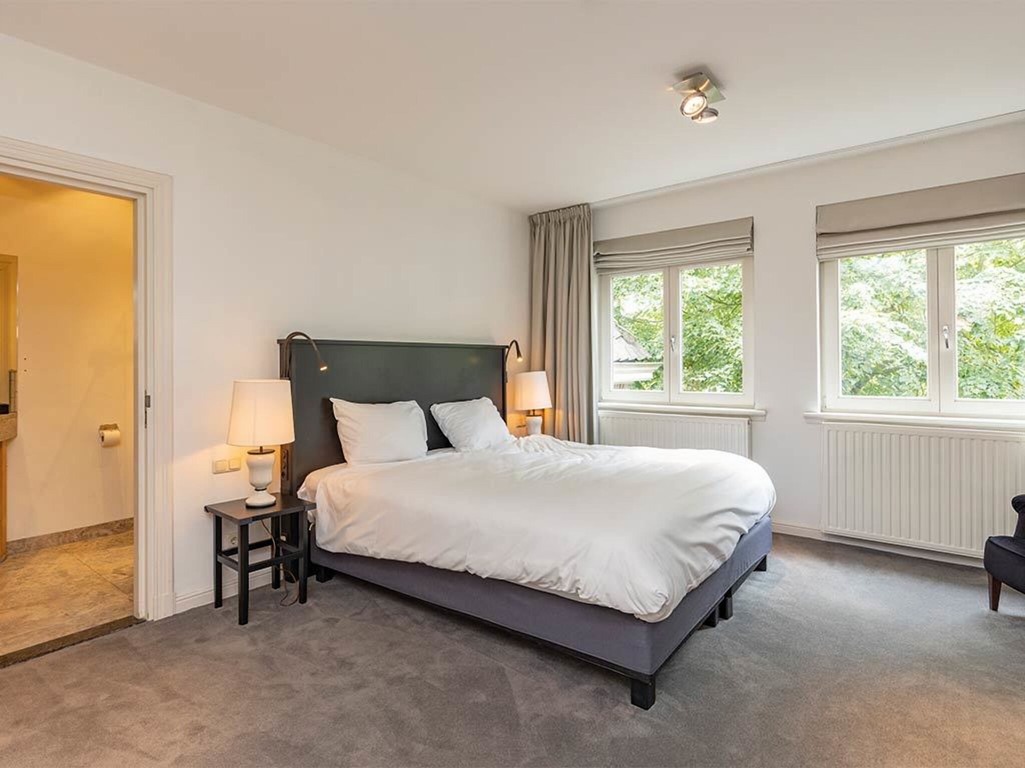 Wake gently to daylight pouring through wide, peaceful windows.