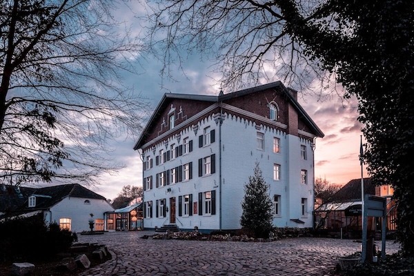 Arrive to a storybook estate glowing warmly at sunset.
