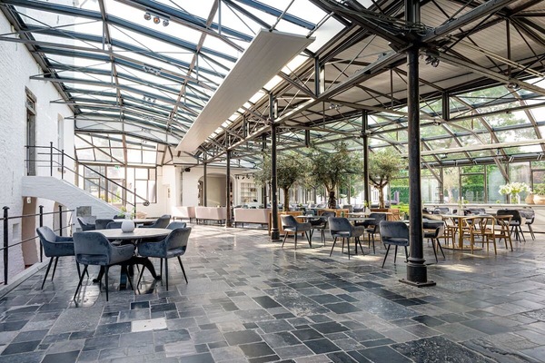 Gather for long, relaxed meals beneath soaring glass ceilings.