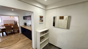 A compact kitchen with dark cabinets, a white countertop, and a small white shelf. - Retreat With Terrace, Parking (Mont-Dore)