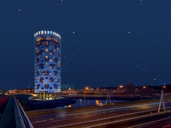 A cylindrical building with a circular pattern on its facade, labeled "HOTEL FLEET." - Perfect Group getaway | Nature escape, Local attractions & Golf course | 2 Units (Amsterdam)