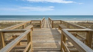 A wooden boardwalk leading to a beach with a clear sky. - Blue Southern Charm 7 Bedroom Home (Georgetown)
