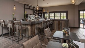 A bar area with high stools, a bar counter, and hanging light fixtures. - 2 Upscale Wassenaar Stay Close To The Beach, Local Hotspots & Nature Reserves (Wassenaar)