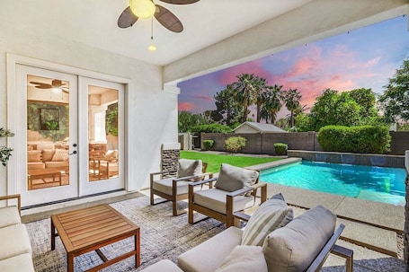 A poolside area with outdoor seating, a view of a swimming pool, and a sunset sky.. The Grove | Pool, Cabana, Outdoor Kitchen, Sleeps 20 | Arcadia, Near Old Town