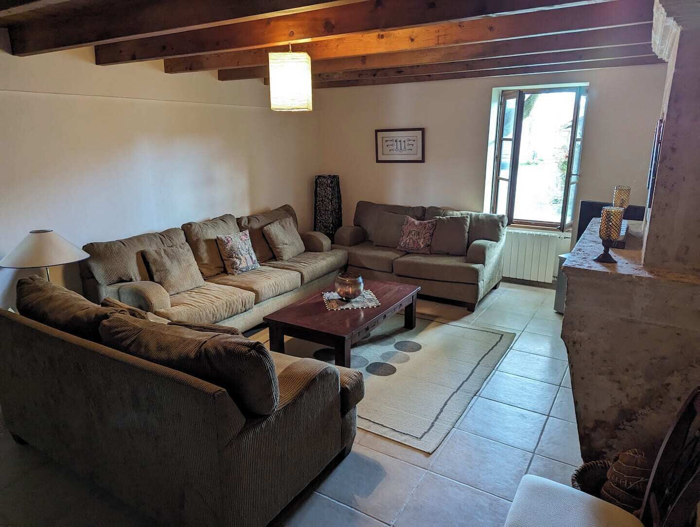 A living room with two sofas, a coffee table, and a fireplace.