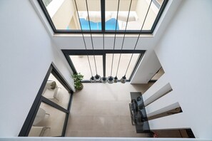 A modern interior with a skylight, a staircase, and a dining area. - Maslenica Villa With Heated Pool (Jasenice)