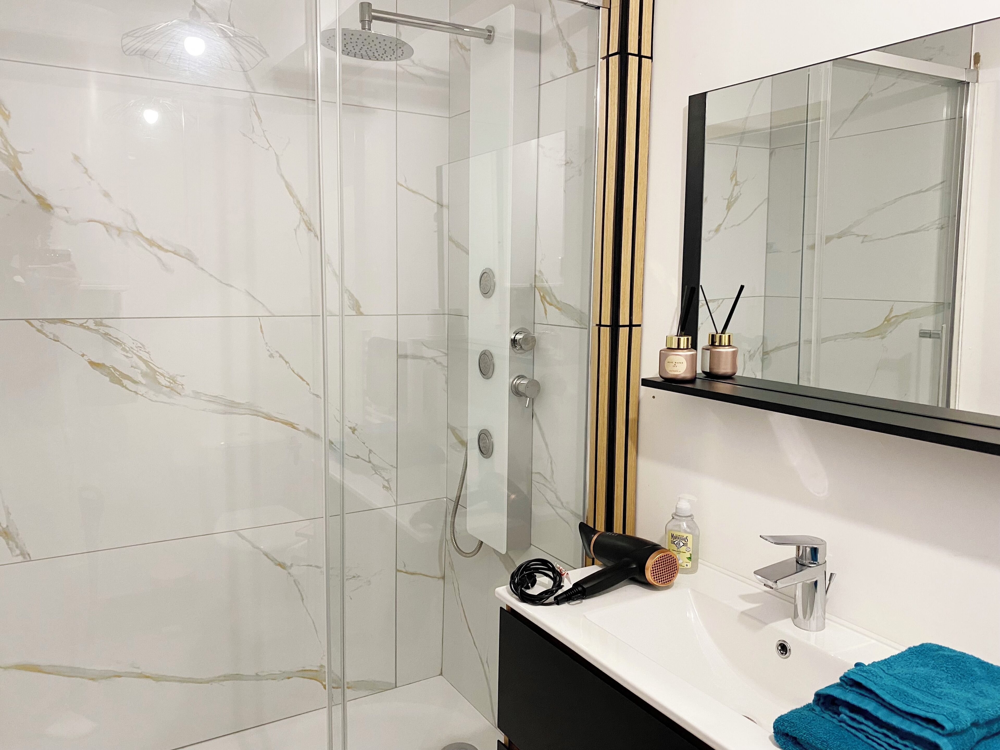 Shower, hair dryer, towels, soap