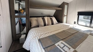 A bedroom with a bed, a window, and a door. - Quiet retreat on beautiful horse farm (Ocala)