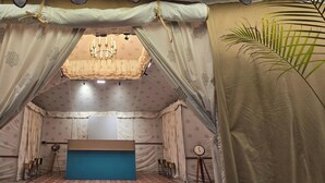 A room with a bed, a chandelier, curtains, and a clock. - Mayura Retreat (Danta Ramgarh)