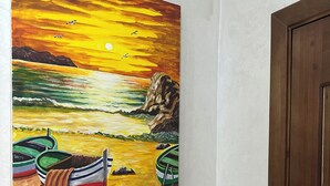 A painting of boats on a beach with a sunset. - Enjoy staying in a calm apatment- near the beach with air conditioning and wifi (Martil)