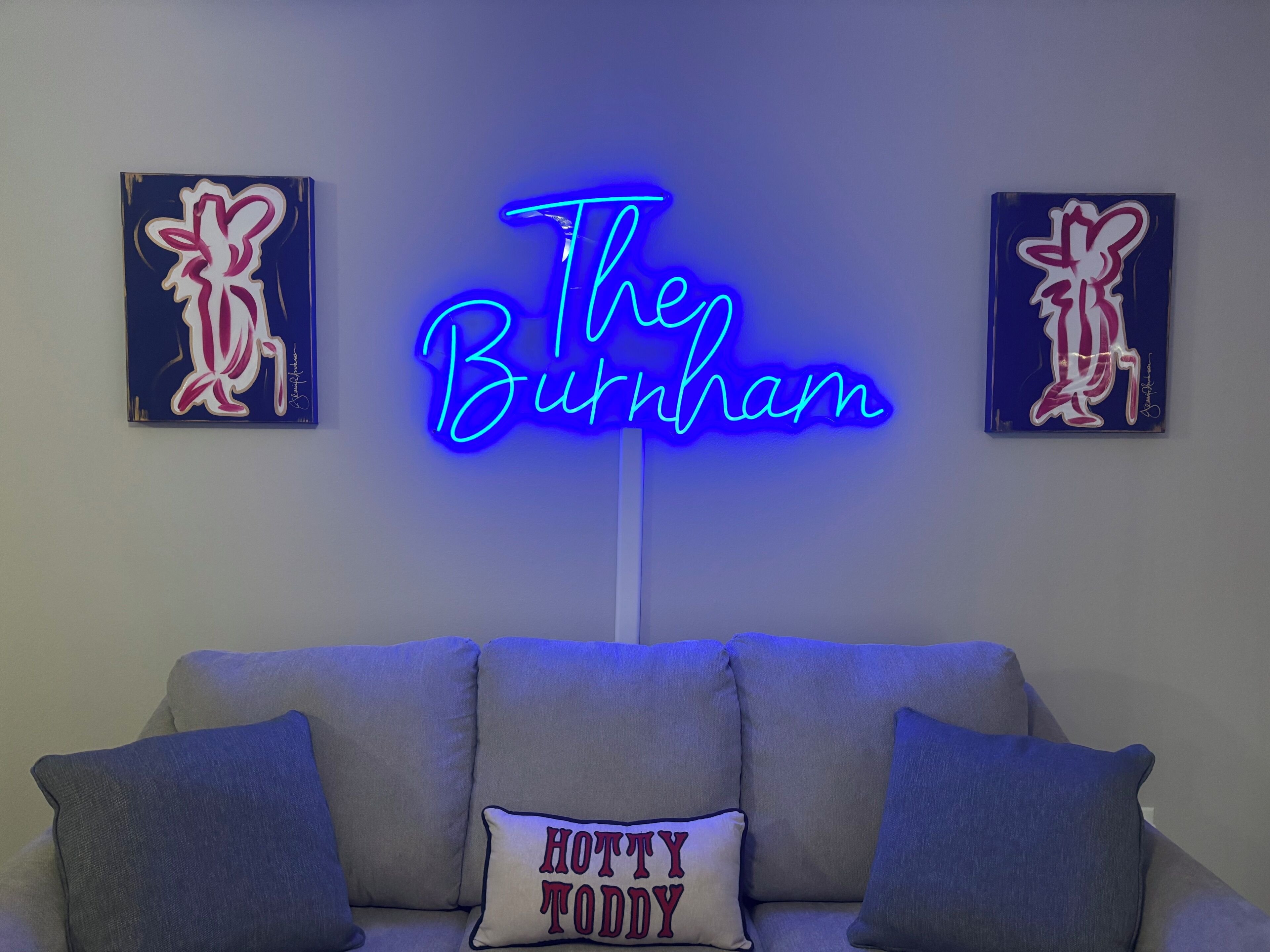 A neon sign reading "The Burnham" in a modern interior setting.