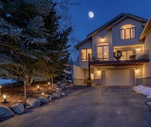 A two-story house with a balcony, a garage, and a driveway. - Pedal and Peak - Fully Renovated - Entire Luxury Home in Dillon (Dillon)
