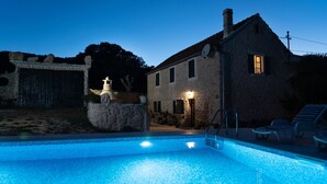 A stone house with a swimming pool, stone wall, and a statue. - House in a Scenic Siveric Park (Drnis)