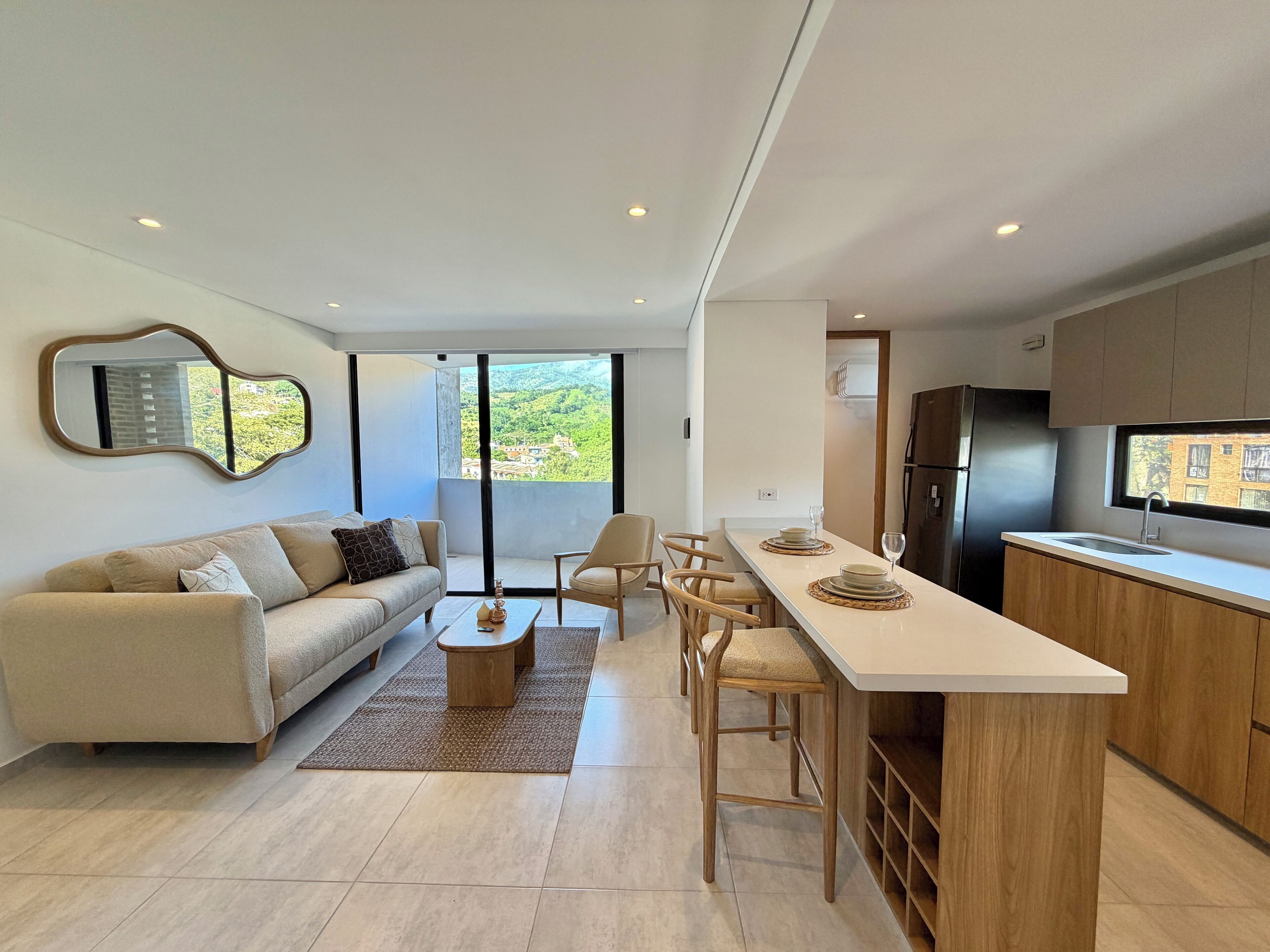 A modern apartment with a living area, dining space, and kitchen.