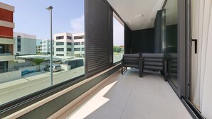 Ein moderner Balkon mit Blick auf eine Straße und Gebäude.