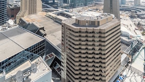 A high-rise building with a modern architectural design, featuring a prominent tower structure. - Aera Toronto - The Entertainment District (Toronto)