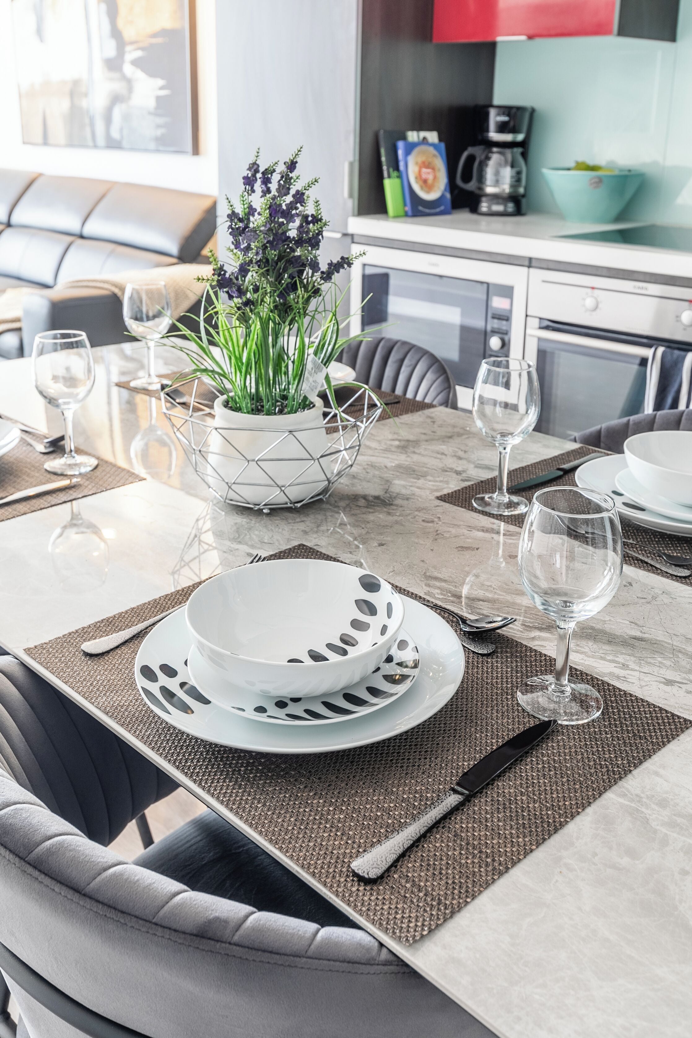 A dining area with a table set for four, including plates, bowls, and cutlery.