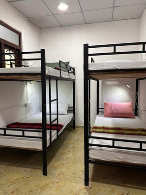 A dormitory room with bunk beds, a window, and a tiled floor. - R BackPacker Hostel (Ahangama)
