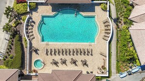 An aerial view of a swimming pool with lounge chairs and a hot tub. - Butterfly House – Organic Garden Retreat in Popular Golf Community (Sarasota)