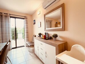 A room with a dining table, chairs, a white cabinet with drawers, a mirror, and a window with curtains. - Sol, Golf & Relax – Luxury house golf & sea (San Jorge)