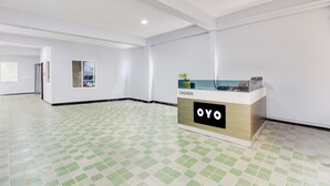 A hotel lobby with a check-in counter labeled "CASHIER" and "OYO". - Hotel O Kotipalli (Rajahmundry)