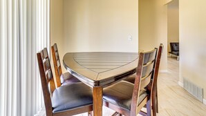 A dining area with a round table and four wooden chairs. - 8 Mi to Bricktown Fun: Quiet Family Retreat (Oklahoma City)