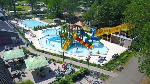 A water park with multiple pools, slides, and a covered seating area. - Enjoy and relax (Marienberg)