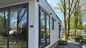 A modern building with large windows and a wooden deck. - Enjoy and relax (Marienberg)