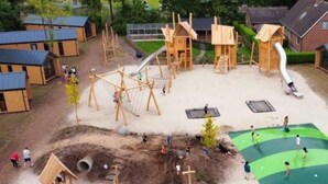 A playground with various play structures, including a slide, swings, and climbing areas. - Enjoy and relax (Marienberg)