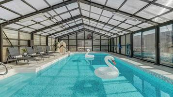 Indoor pool, open 9:00 AM to 9:00 PM, pool loungers