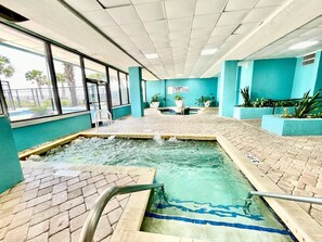 An indoor pool area with tiled flooring, a central water feature, and potted plants. - 1Br sleeps 4 Spacious beach getaway 746 (Myrtle Beach)