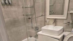 Un baño con bañera, lavabo, inodoro y ducha.