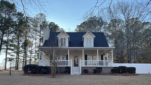 A two-story house with a front porch, a chimney, and a white fence. - Quiet Pines by Abner.
Welcome to our small cottage retreat among the pines. (Valley)