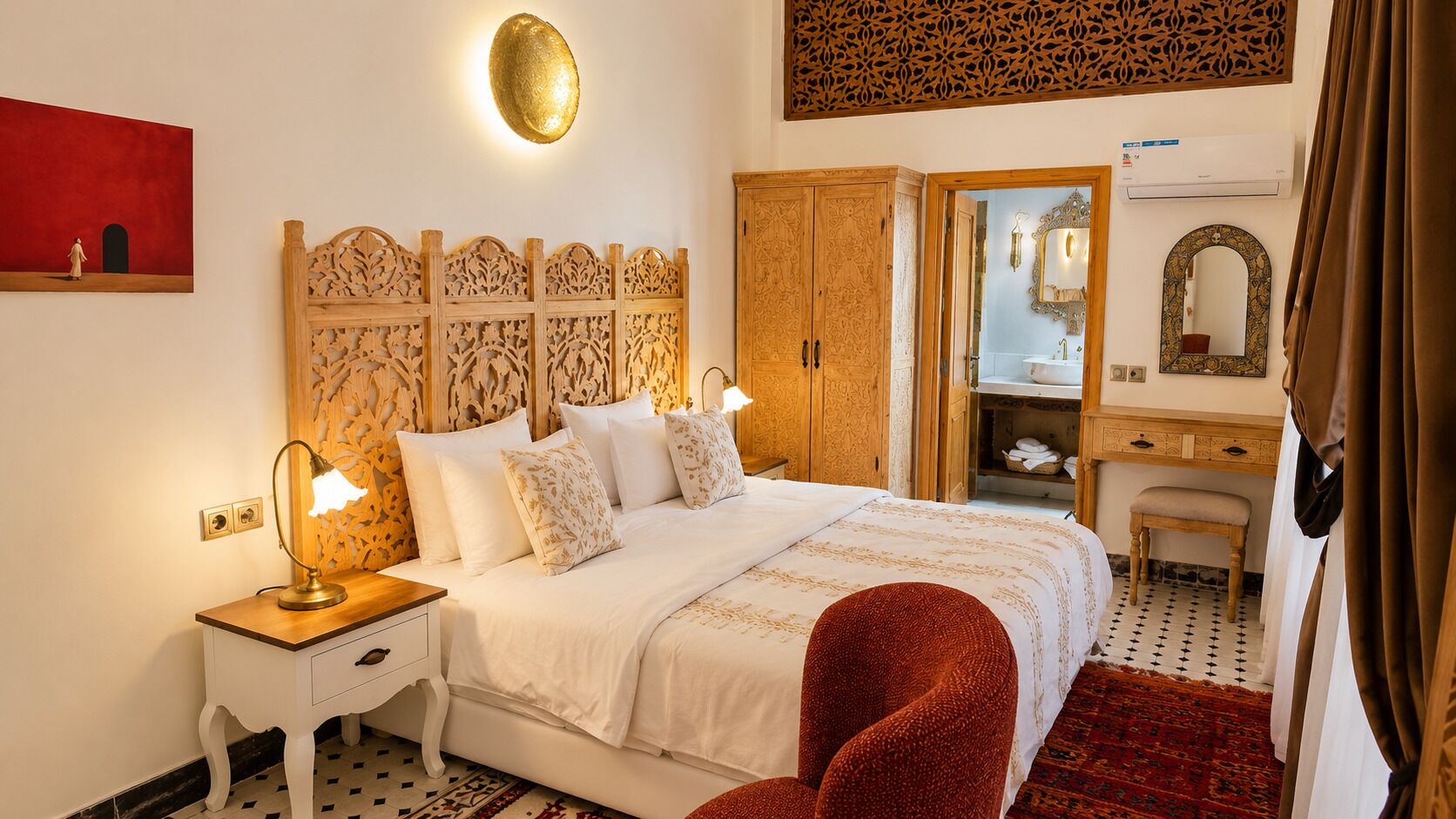 A hotel room with a bed, bedside tables, a mirror, a wardrobe, and a bathroom visible through an open door.