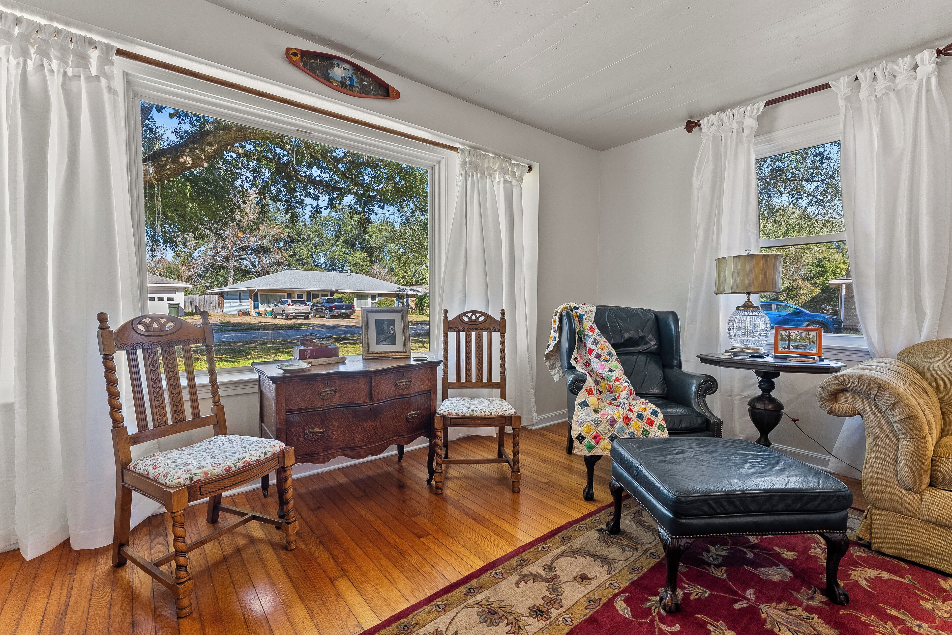Cozy seating by the picture window with peaceful live oak views.