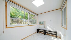 A room with large windows, a bench, and a tiled floor. - Gapyeong Ruba Pension (Gapyeong)