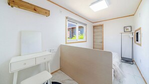 A bedroom with a bed, a bedside table, a wardrobe, a window, and a mirror. - Gapyeong Ruba Pension (Gapyeong)