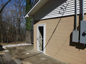 A building with a brick exterior, a door, and a utility box.