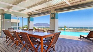 Outdoor dining - An Exceptional Beachfront Retreat (Cape Town)
