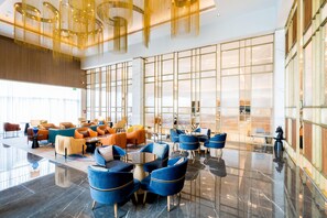 A spacious lobby with modern seating, large windows, and a high ceiling. - Holiday Inn Lucknow Airport (Lucknow)