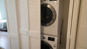A laundry room with two stacked front-loading washing machines.