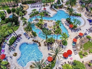 A resort with multiple swimming pools, sun loungers, and palm trees. - 4br Resort Home With Pool And Lazy River Sleeps 10 4 Bedroom Townhouse (Davenport)