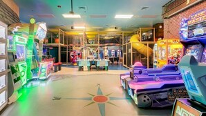 An indoor arcade with various gaming machines, including racing and shooting games. - Fully Themed Harry Potter Getaway Close Disney 3 Bedroom Townhouse (Davenport)