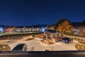 A parking area with a building, a car, and a mountain backdrop. - Starlight Escape | Lake Views + Balcony (Lake Tekapo)