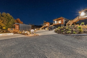 A modern residential area with multiple houses connected by a pathway, featuring a gravel driveway and landscaped areas. - Starlight Escape | Lake Views + Balcony (Lake Tekapo)