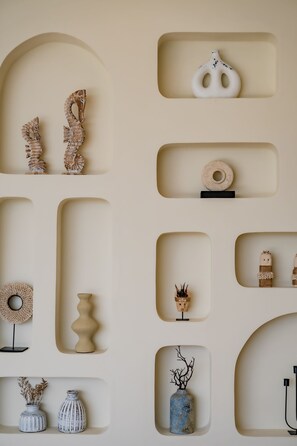 A wall with various shelves displaying decorative items. - Villa Bingin Hills Cinco (Pecatu)