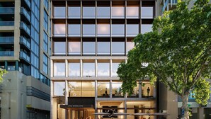 A modern hotel with a glass facade, outdoor seating, and a visible entrance. - Little National Hotel Adelaide (Adelaide)